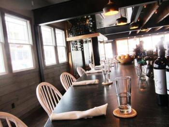 A curved granite bar counter and glass enclosed two-story wine room are the prominent features of Hoxbill restaurant in Camden. (Photos by Kay Stephens)