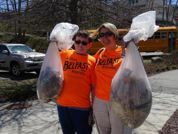 Martha Conway-Cole stands beside a student with some of the trash they picked up. (photo by Erica Thoms)