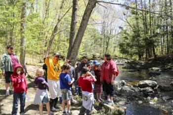Students release Salmon fry into the Wescot Stream in Waldo. 12 Waldo County schools participated in the “Fish Friends” program. (Photo courtesy of Alice Seeger)