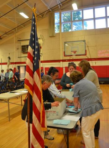 Official municipal representatives count the ballots. (Photo by Lynda Clancy)