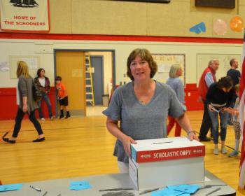 Camden Town Clerk Katrina Oakes keeps the ballot box safe. June 11, Camden-Rockport Middle School gym. (Photo by Lynda Clancy)