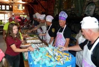 Waldo County Sheriff Jeffrey Trafton can be seen second from the left, serving campers in the chow line. (photo courtesy of Erica Koch, of Volunteers of America)