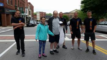 Graham Wiley (third person from left), gathers with the runners from the Camden and Rockport Police Departments before they take off for the annual Law Enforcement Torch Run. (Photo by Sarah Shepherd)