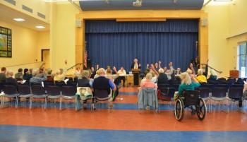 Lincolnville citizens unanimously approved an amendment to the town meeting warrant to combine 10 articles at the end of the warrant into one, thus moving the town meeting swiftly to conclusion. (Photo by Lynda Clancy)