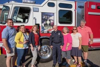 Members of Knight’s family, including his wife Barbara, (on his right), gathered for the surprise celebration. (Photo by Peter Ralston)