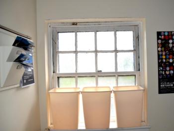 Trash cans strategically line some windows in the back of the Opera House, for when the rain enters the building.