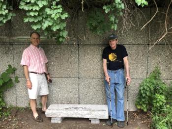 Camden-Rockport Pathways Committee Chairman Geoff Scott with Mac Thomas, at the granite bench honoring Thomas. Owen Casas, of Rockport, carved and engraved the stone. (Photo by Lynda Clancy)
