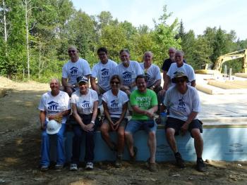 Volunteers pose with future homeowner Michael Curtis. (photo by Erica Thoms)