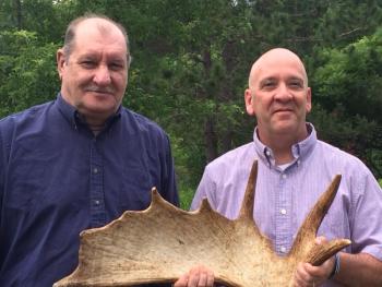 Students brought items to offer at an auction near the end of the 10-week program. Retired Waldo County Sheriff’s Deputy Gene Rego (left) donated a moose shed he had discovered in Maine’s northern woods.