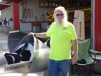 Robert Dodge poses with his homemade aircraft. (photo by Erica Thoms)