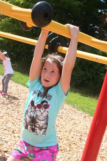 Alora Stewart hangs from the monkey bars. (Photo courtesy Thomaston Grammar School)