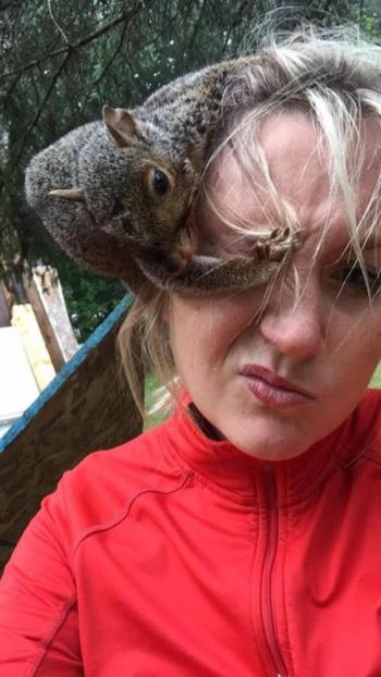 Kristen and Paul, the miraculous gray squirrel who she rescued from the roadway and nursed back to health.