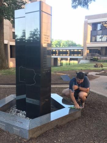 A member of the 273rd session cleans a Sept. 11, 2001, memorial at the FBI’s Quantico Virginia campus. (photo courtesy of Chief Deputy Trundy)
