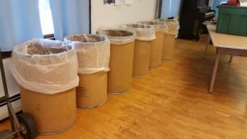 35-50 gallon drums containing donated pet food are transported to the American Legion Hall in Camden from Rokes Storage Farm, also in Camden, once a month for volunteers to assemble donation bags. (Photo by Sarah Shepherd)