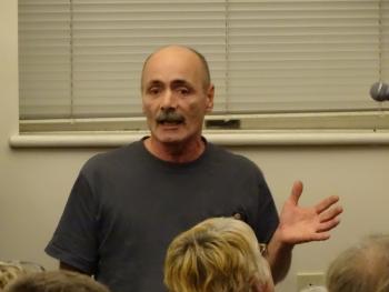 A former Maine Coastal Regional Reentry Center resident speaks to the crowd. (photo by Erica Thoms)