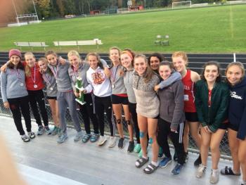 The Camden Hills girls cross country team with a first place trophy. (Courtesy Steve Alex)