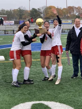Camden Hills celebrating its third consecutive state championship. (Courtesy Steve Alex)