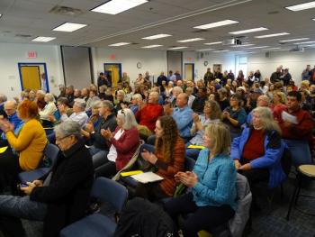 The crowd applauds Harkness’ words. (photo by Erica Thoms)