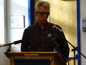 Roger Heinan, who moved to Islesboro in the 90s, takes to the podium. (photo by Erica Thoms)