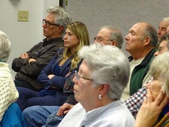 District 11 Senator Elect Erin Herbig listens amongst the crowd during the meeting. (photo by Erica Thoms)