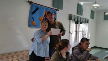 Andrew Lowe cheerfully accepts his raffle prize. (Photo by Sarah Shepherd)