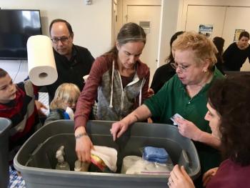 Hebrew school volunteers and students filling Welcome Home Kits. (Photo courtesy of Elizabeth Siegel)