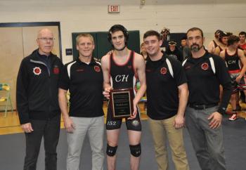 Noah Lang and the Camden Hills coaching staff as Lang is recognized for his 100th match victory by pin. (Courtesy Glenn Lang)