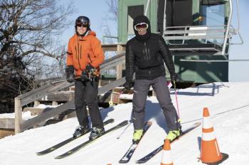 Andre LeBlond, of Rockport, and Glen Plake disembark at the top of Ragged Mountain at the Camden Snow Bowl. (Photo courtesy Camden Snow Bowl/by John Steele)