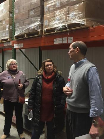 Rep. Ann Matlack and Rep. Kristen Cloutier listen during tour of Good Shepherd Food Bank. (Photo courtesy of Vicki Doudera)