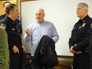 Belfast Police Chief Michael McFadden (left) and Detective Gerald Lincoln (right) talk with a fellow member of law enforcement. (photo by Erica Thoms)