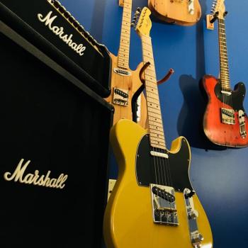 Guitars line the wall next to an amplifier in Thad Chilton’s showroom. (Courtesy Thad Chilton)