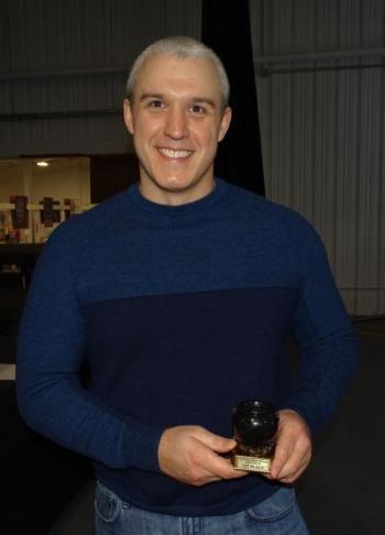 Colson poses with last year’s trophy. (photo by Erica Thoms)