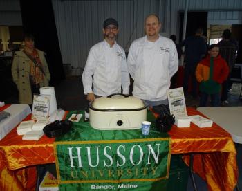 Shawn Stemp left) and Nick Andrei (right) were at the event representing Husson University and said their chili is sweet and smoky. They said the chili was made by a chef who was unable to attend the competition. (photo by Erica Thoms)