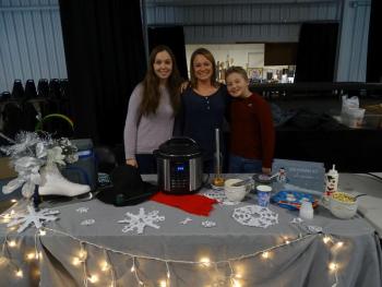Jill Artkop (center) poses with her children MiKayla (left) and Riley (right). Artkop said this is her first time at the cook-off and that she was inspired to enter by her love of cooking. “I don’t care if I win, it’s just getting my name out there,” she said. She said her children are her biggest helpers. (photo by Erica Thoms)