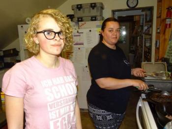 A staff member stands near Natasha Kendal, who is the food service manager for the Game Loft.