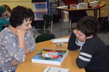 Grade 3 teacher, Rose Richter and Owen deLorimier play Chinese Checkers as during a stay-cation trip around the world. (Photo courtesy Thomaston Grammar School)
