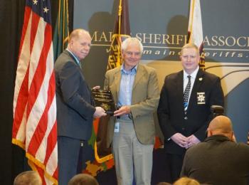 Dr. Hughes accepts the Outstanding Achievement Award from the Maine Sheriffs Association. (photo courtesy of the Waldo County Sheriff’s Office)