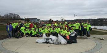 The Troy Howard Middle School’s sixth-grade team poses in front of the garbage they collected from Belfast’s streets May 2. (photo by Erica Thoms)
