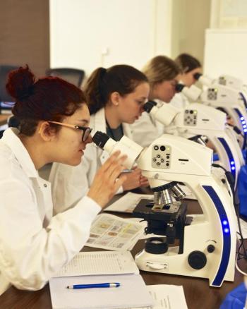 Keller BLOOM students Sydnie Della Croce, Katherine Bowen, Jordan Snell, and Camille Michaud focus their microscopes on phytoplankton they collected during a local research cruise. The high school students participated in the 30th annual Keller BLOOM program, completing a week of hands-on science learning at Bigelow Laboratory for Ocean Sciences. Robert Mitchell photo