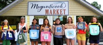 Seventh-grade students from Camden-Rockport Middle School line up in front of Megunticook Market to show off their work. (Photo by Ellen Curtis)
