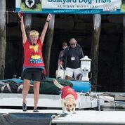 Humor is a key ingredient at the trials, where the watchword is fun. Here, World Champ Zola and her wonder person celebrate their victory. (Photo by Bell’s Furry Friends Pet Photography)