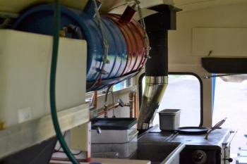 The water pump and wood-fired oven set up inside Rockport Harbor Food Bus. (Photo by George Harvey)
