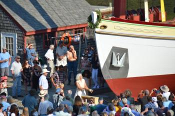 Martha White sweeps the bottle of champagne against the bow of the Underwood just before the boat is settled into the water.