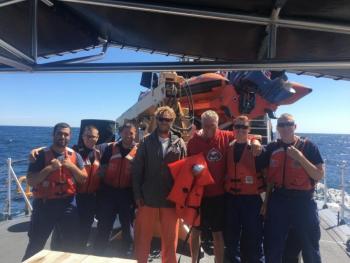 Coast Guard Cutter Ocracoke's small boat crew poses with the two boaters rescued off the coast of Maine, Sunday, Aug. 11, 2019. The boaters were taken to Gloucester, Massachusetts. (U.S. Coast Guard photo by Seaman Michael Neo)