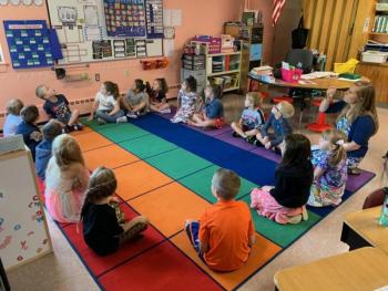 Miss Wotton’s first grade class gathers for circle time.