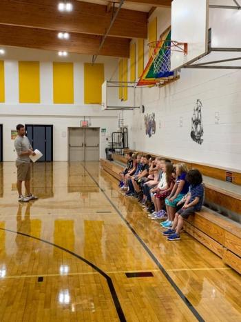 Second grade students receives instructions from physical education teacher Mr. Petrie.