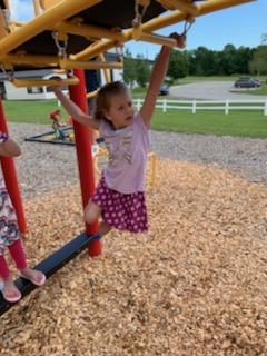 Greta Stinson plays on the monkey bars at recess.