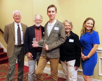 Pictured L-R with Unsung Hero, Linford Young, center, are John Viehman, Courier Publications; Ray Estabrook, Game Loft; Patricia Estabrook, Game Loft; and Megan Williams, UMC Executive Director. (Photo by Marti Stone)