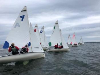 Racers approaching the start line at full speed under grey skies and solid breeze. Nine boats sailed on the line, with five of the teams calling the Apprenticeshop their “home” program. (Photo by Ken Pride)