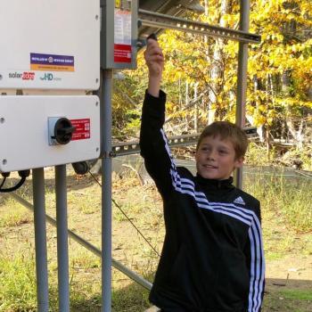 Islesboro Central School fifth grade student Jaykob Zolllman flips the switch at a ceremony Oct. 9. (Courtesy Charles Hamm)